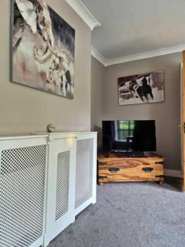 a living room with a television and a table at Bungalow Bliss in Carlow