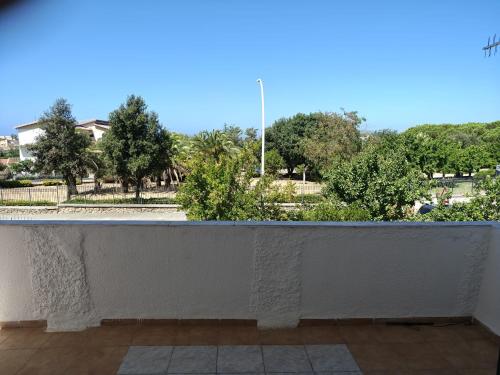 a white wall with a view of a park at Tidale Host house B&B in Alghero