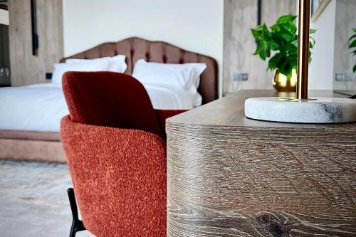 a bedroom with a bed and a table and chairs at Fins Dream Villas in Fins