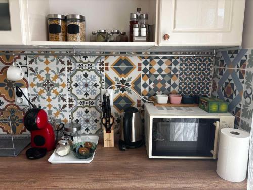 a kitchen counter with a microwave oven in a kitchen at АпартаменЪТ у Град in Belogradchik