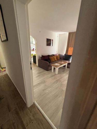 a living room with a couch and a table at АпартаменЪТ у Град in Belogradchik