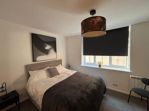 a bedroom with a bed and a window at New City Centre Flat No 2 2 Bedroom Free Parking in Leicester
