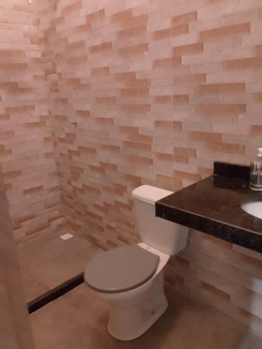 a bathroom with a toilet and a sink at casas em búzios 8 in Búzios