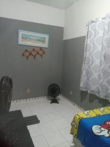 a small room with a bed and a window at Quarto - Room de hóspedes da Menina Maricotinha 2 in Manaus