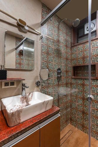 a bathroom with a sink and a shower at CASA ALBELA - designer luxe 1BHK suite , Central Bangalore in Bengaluru