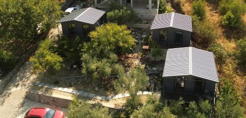 an aerial view of two cottages with trees at Lake Escape Villa Shirokë in Shkodër
