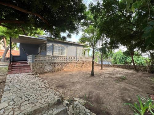a house with a stone driveway in front of it at Surfer Grill Accommodation - Pradomar PC Experience in Puerto Colombia