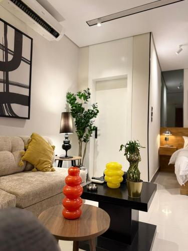 a living room with a couch and a table at جناح فاخر قريب في شمال الرياض الملقا in Riyadh
