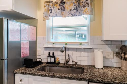 a kitchen with a sink and a window at 3BR Getaway Hot Tub Games Family Fun in Charlotte