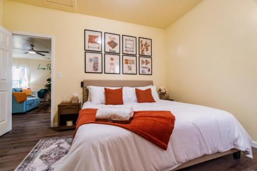 a bedroom with a large bed with orange and white pillows at 3BR Getaway Hot Tub Games Family Fun in Charlotte
