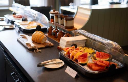 a buffet with a tray of food on a counter at voco The Club - Dublin Gateway by IHG in Naas