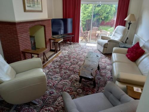 a living room with couches and a fireplace at Central to town, 4 bedrooms, sleeps 8, parking for 4 plus cars in Stratford-upon-Avon