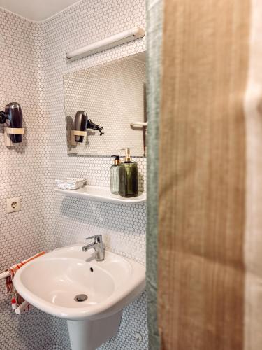 a bathroom with a sink and a mirror at Hotel Restaurant Ratsstube in Calw