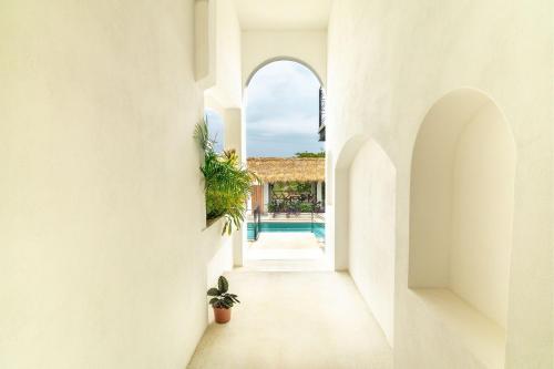 a hallway leading to a pool in a villa at CNonoru in Puerto Escondido