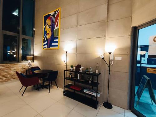 a living room with a table and a dining room at The Luxe By klcc infinitum in Kuala Lumpur