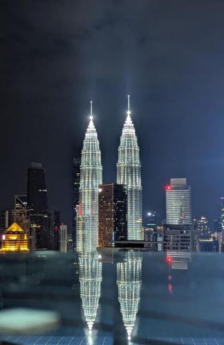 a view of a city skyline at night at The Luxe By klcc infinitum in Kuala Lumpur