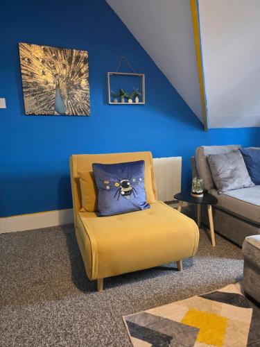 a living room with a couch and a chair at Sleek & Vibrant - 8ight Havens Folkestone in Folkestone