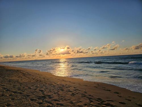 a sunset on a beach with the ocean at Pelican Dock Apartments in Aguada