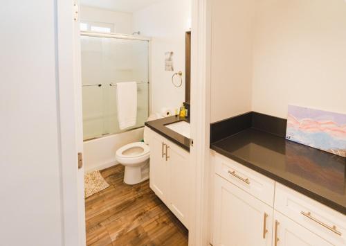 a white bathroom with a toilet and a sink at Modern 1 Bedroom Apartment Near Hollywood and Koreatown Free Gated Parking Full Kitchen in Los Angeles