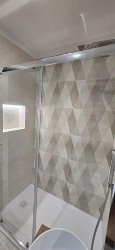 a shower stall with a toilet in a bathroom at Bellini Holiday House in Mola di Bari