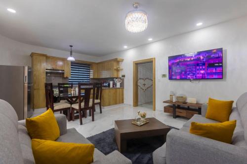 a living room with two couches and a kitchen at Litzie Apartment in San Felipe de Puerto Plata