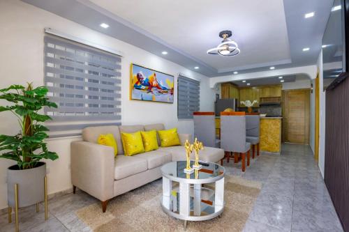 a living room with a couch and a table at Litzie Apartment in San Felipe de Puerto Plata