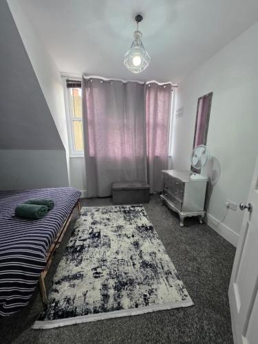a bedroom with a bed and a dresser and a mirror at Sleek & Vibrant - 8ight Havens Folkestone in Folkestone