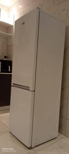 a white refrigerator freezer sitting in a kitchen at Cutting Edge Guest House in Daranka