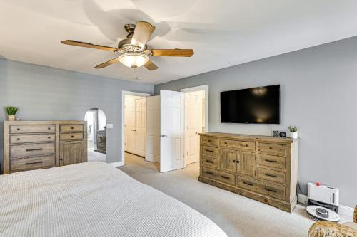 a bedroom with a bed and a flat screen tv at Townhome 3 Mi to Wescott Park and Golf Course! in Ladson