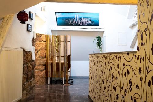 a living room with a tv on the wall at Dachgeschosswohnung mit Klimaanlage-15min vom Europa Park entfernt in Kenzingen