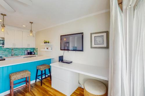 a kitchen with a counter and two stools at Sea Cabin 227-B in Isle of Palms