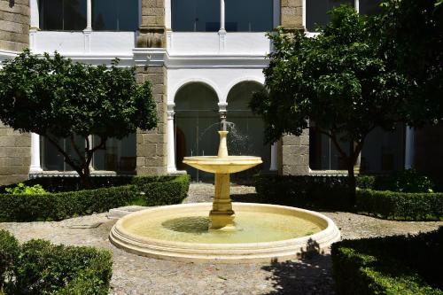 a yellow fountain in front of a building at Pousada Convento de Arraiolos in Arraiolos