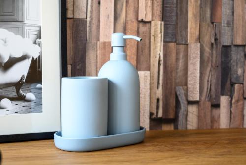 a bottle of soap and a cup on a table at L'Atelier du Château in Langeais