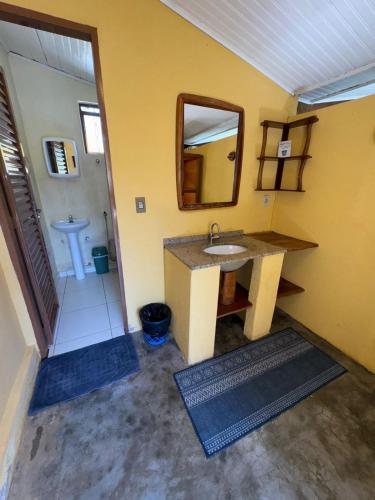 a bathroom with a sink and a mirror at Pousada Loquinhas in Alto Paraíso de Goiás