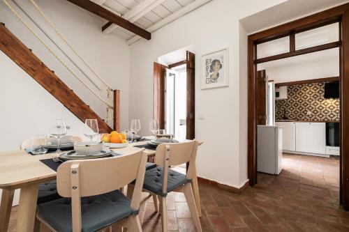 a kitchen and dining room with a table and chairs at Casa das Letras by east ALgarve guest in Tavira