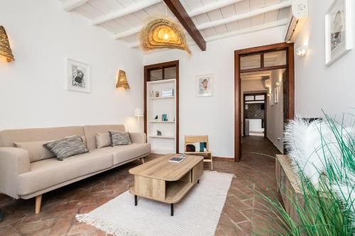 a living room with a couch and a coffee table at Casa das Letras by east ALgarve guest in Tavira