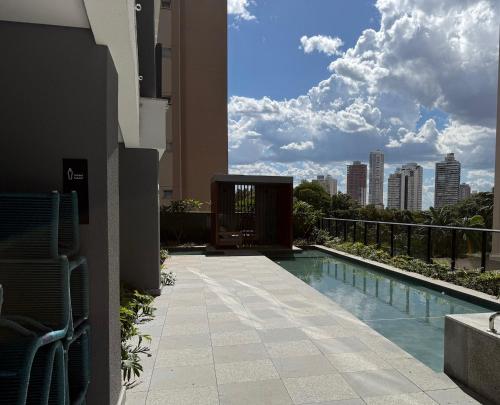a swimming pool with a view of the city at Apt 1 Quarto Luxuoso - Gyro Vaca Brava in Goiânia