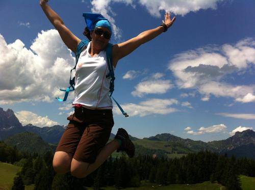 a woman jumping in the air with her arms in the air at Appartement Krepper in Erpfendorf