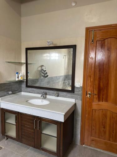 a bathroom with a sink and a mirror at The Meadow View Lodge in Hyderabad