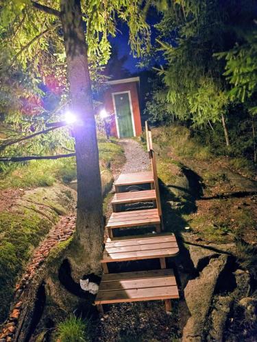 a set of wooden steps leading up to a tree at Stuga utanför Fjällbacka in Fjällbacka