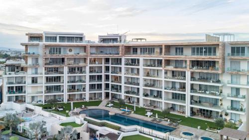 an aerial view of a large building with a swimming pool at 2 Bedroom Residence Live Aqua La Paz in La Paz