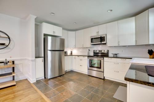 a kitchen with white cabinets and a stainless steel refrigerator at Contemporary Athens Home Less Than 2 Miles to UGA! in Athens