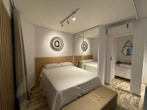 a bedroom with a large bed and a mirror at Unique (Ex-Estanconfor) veja o mar do apto 2302 in Santos