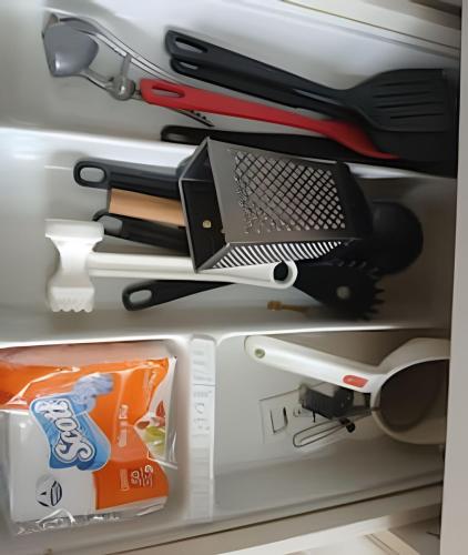 a refrigerator filled with lots of tools and a laptop at Conforto familiar – Wi-Fi veloz e 1 min da praia in Santos