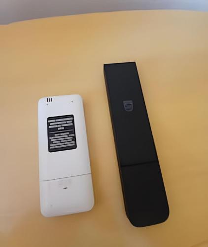 two electronic devices sitting next to each other on a table at Conforto familiar – Wi-Fi veloz e 1 min da praia in Santos