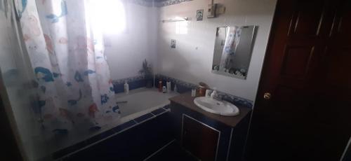 a bathroom with a sink and a shower curtain at Villa Solace in Ban Pho Touane