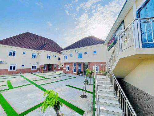 a large building with a courtyard in front of it at Kaygold hotel and suite in Gwagwalada