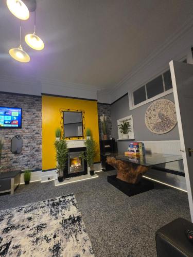 a living room with a fireplace and a tv at Charming & Energetic - 8ight Havens Folkestone in Folkestone