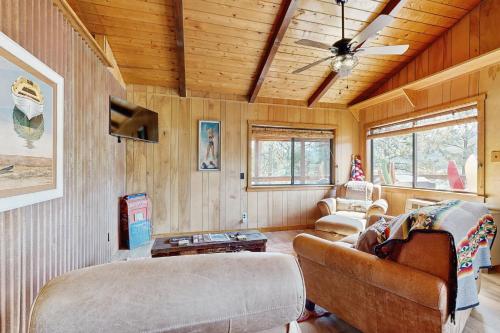 a living room with wooden walls and a ceiling at Lakefront Cabin Retreat (Cabin A) in Vallecito
