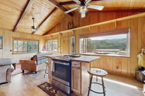 a kitchen with wooden walls and a ceiling at Lakefront Cabin Retreat (Cabin A) in Vallecito